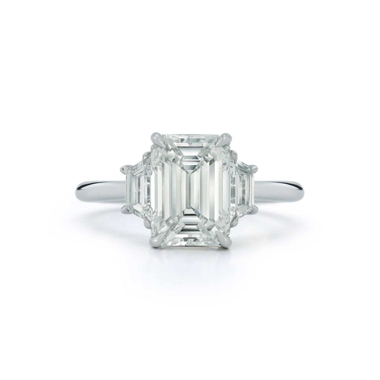 The Lauren Engagement Ring with emerald cut center stone and emerald cut stones on either side with platinum band