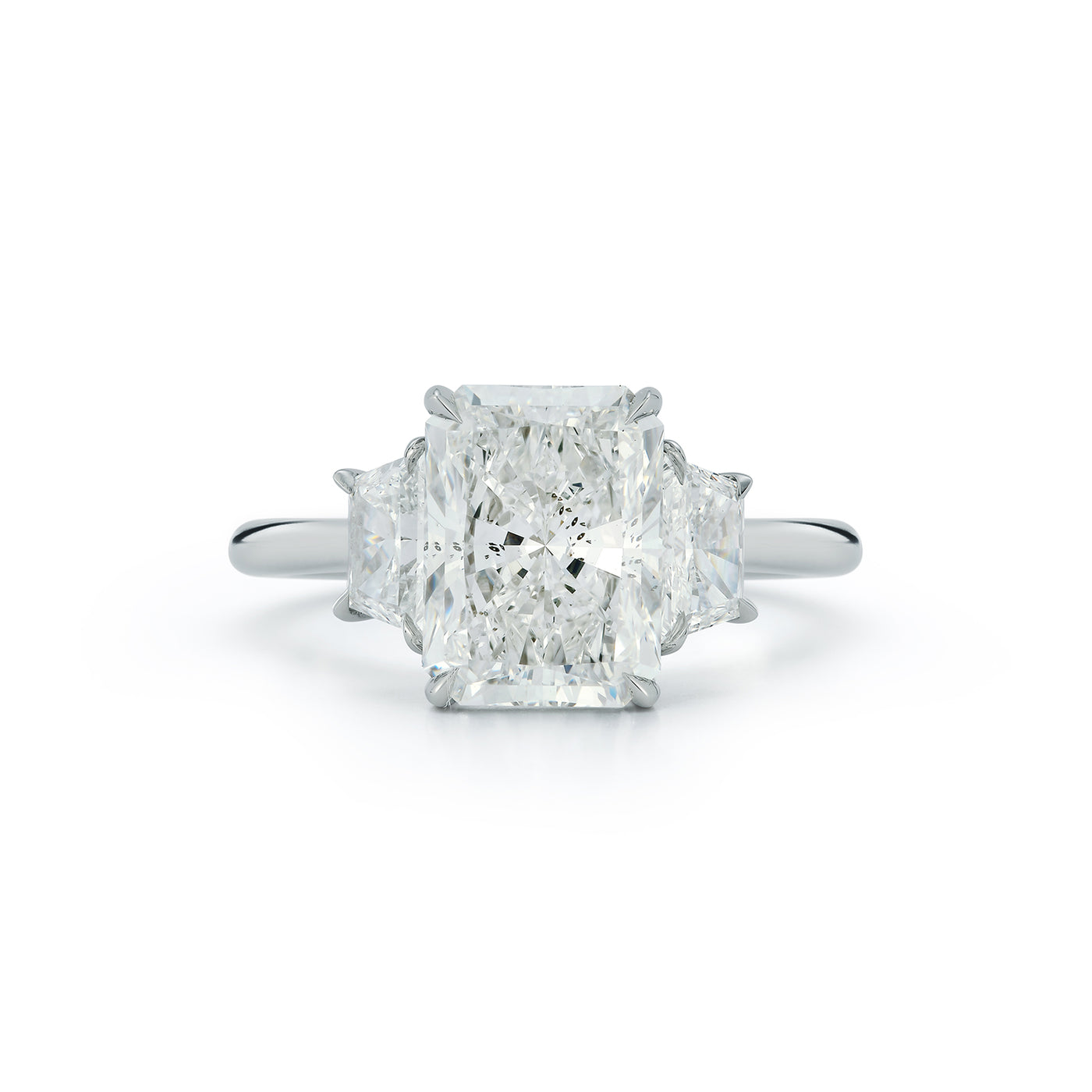 The Lauren Engagement Ring with cushion cut center stone and cushion cut stones on either side with platinum band