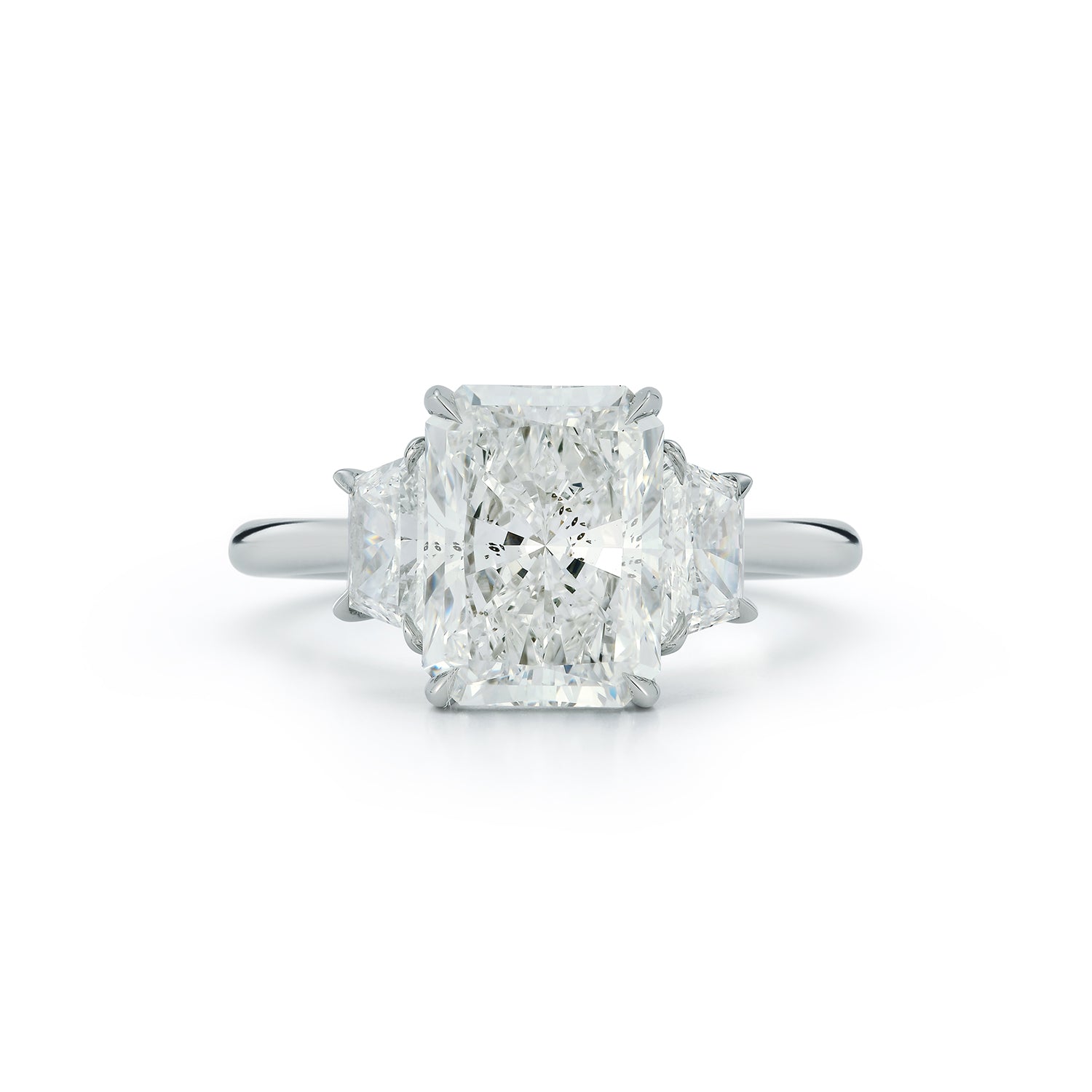 The Lauren Engagement Ring with cushion cut center stone and cushion cut stones on either side with platinum band