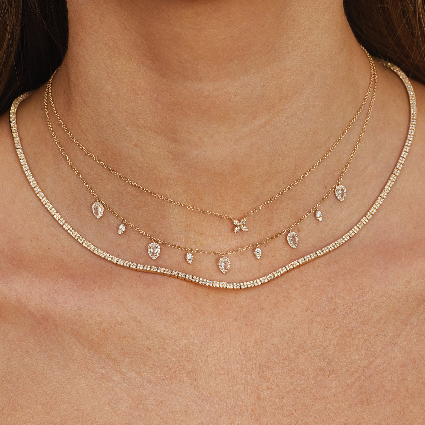 Diamond & White Quartz Ultimate Teardrop Necklace styled on neck of model with gold and diamond necklaces