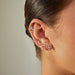 Diamond Cluster Dangle Stud Earring in 14k yellow gold styled next to four diamond earrings on ear of model