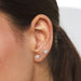 Heart Diamond Solitaire Stud Earrings styled on first and second hole on ear lobe of model