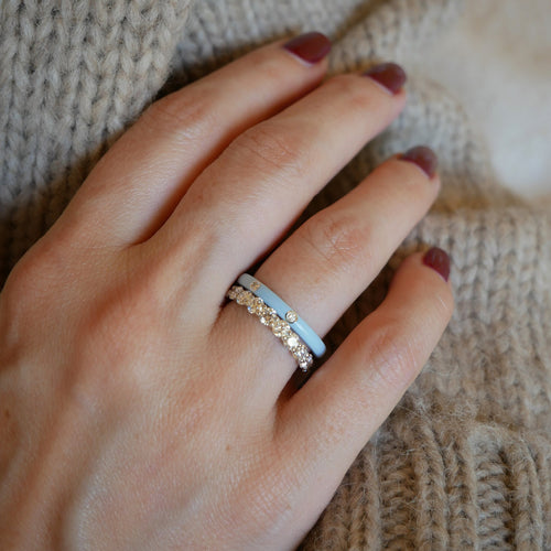 3 Diamond Baby Blue Enamel Stack Ring in 14k yellow gold styled on ring finger of model with diamond ring