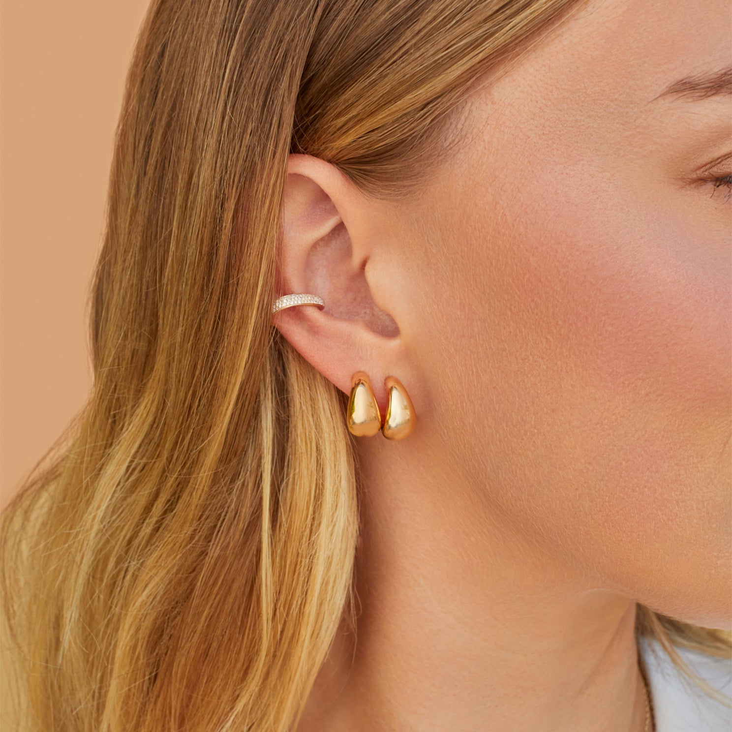 EF Collection 14k yellow gold earrings styled on ear lobe of model