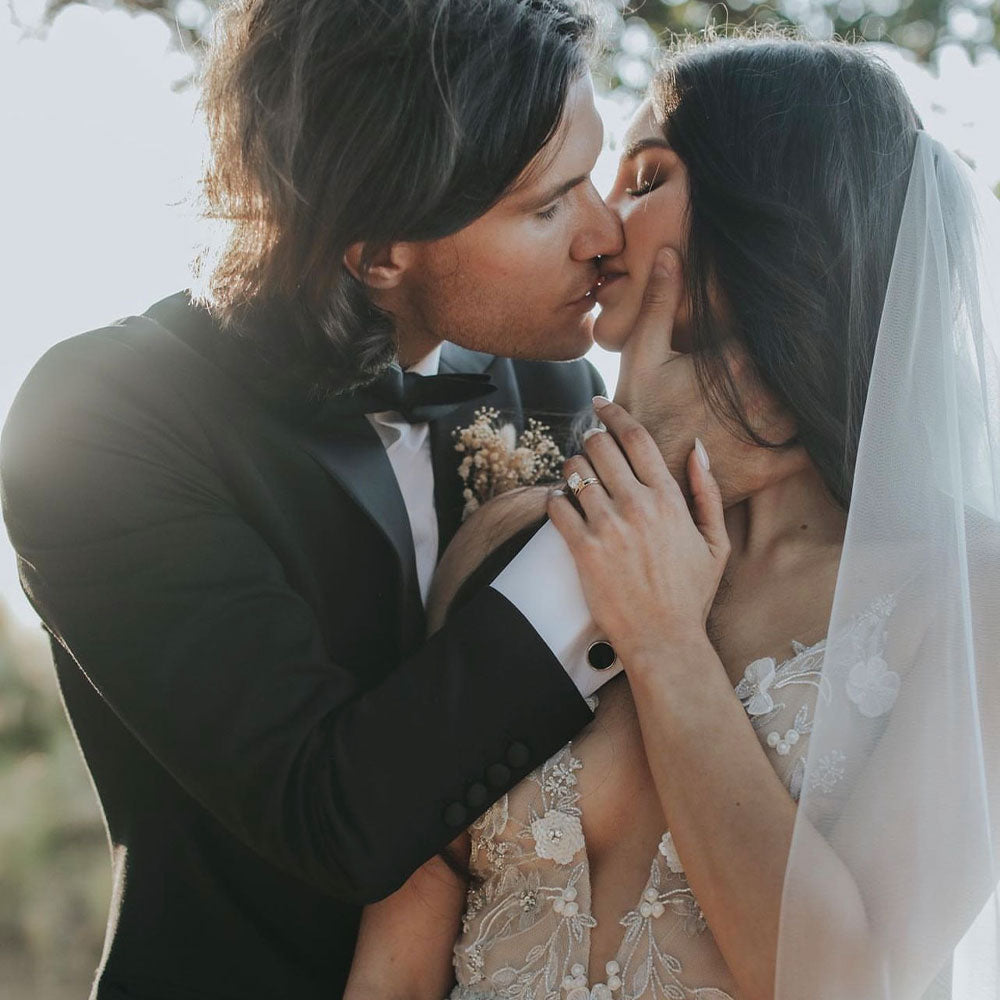 Coupon embracing with model styled with EF Collection engagement ring on ring finger