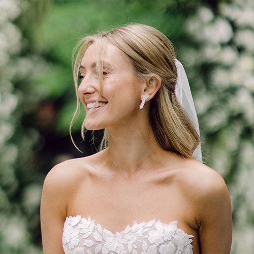 EF Collection diamond pretty lady earring styled on ear of model in white top
