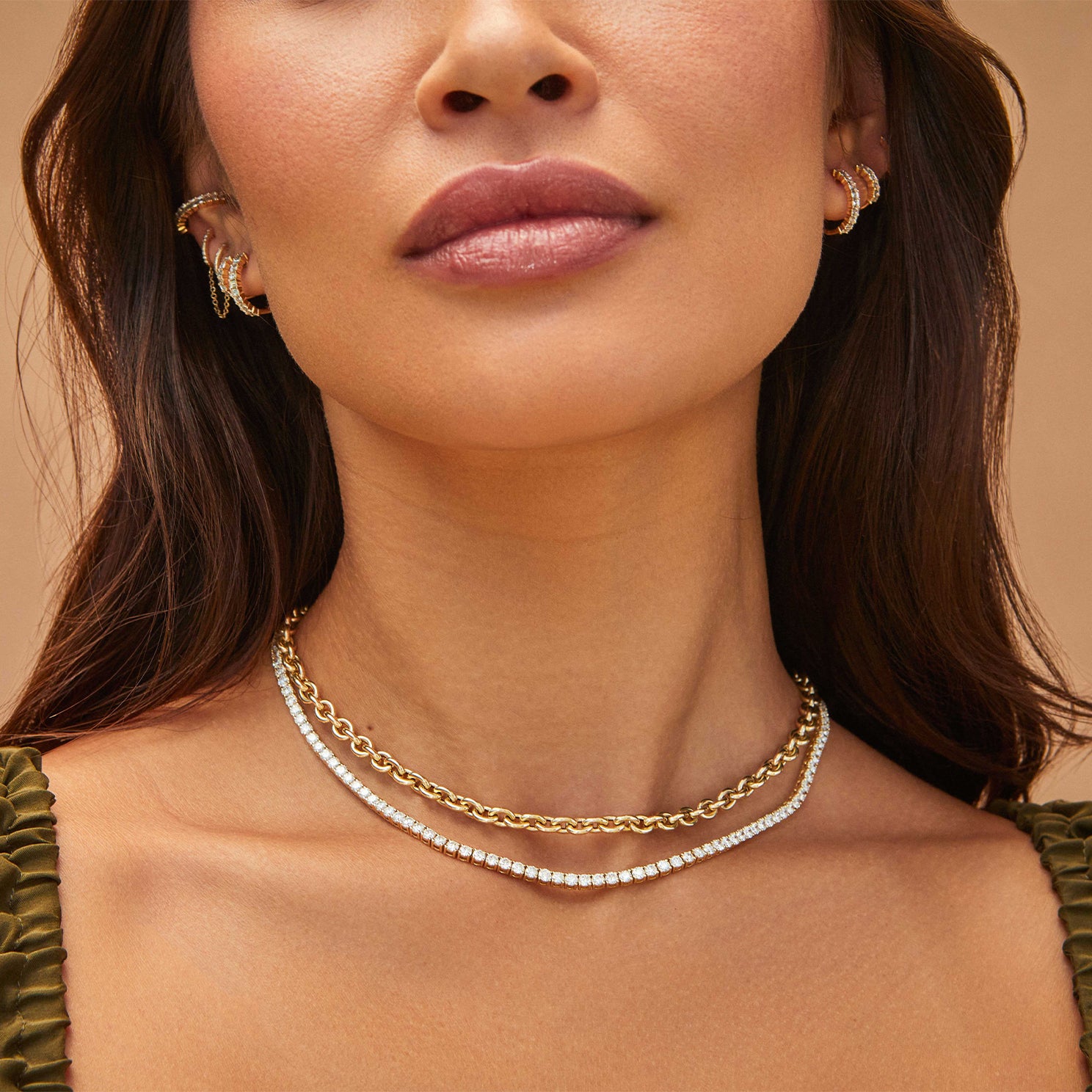 Diamond Tennis Necklace in 18k yellow gold styled on neck of model with gold chain necklace 