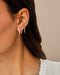 Diamond Baguette Jumbo Lola Hoop Earring in 14k yellow gold styled on ear lobe of model