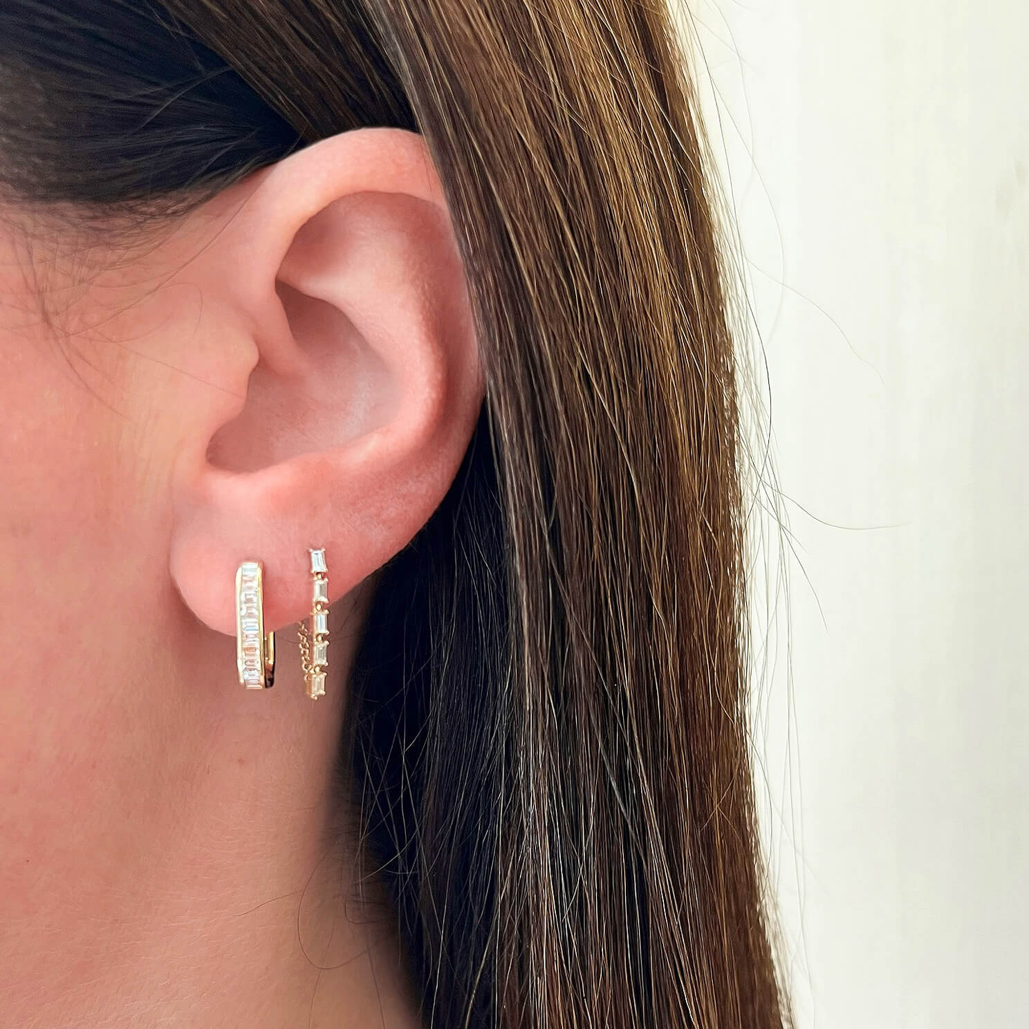 Multi Diamond Baguette Chain Stud Earring in 14k yellow gold styled on ear lobe of model in second piercing hole