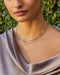 Graduated Diamond Pillow Necklace in 14k yellow gold styled on neck of model with jumbo link diamond pillow necklace and lariat necklace