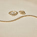 Graduated Diamond Pillow Wrap Ring in 14k yellow gold next to diamond pillow huggie earrings and diamond pillow bracelet