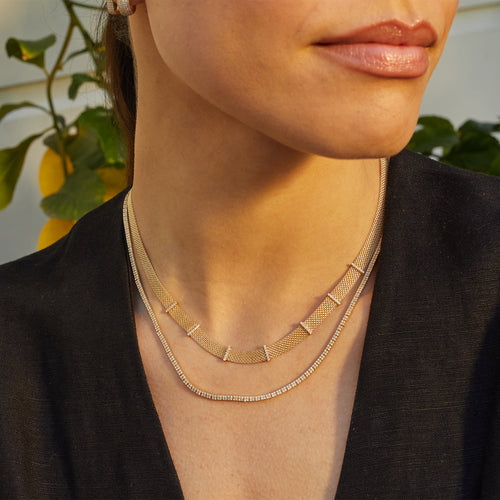 Margo Necklace in 14k yellow gold styled on neck of model with mesh necklace and model wearing black blouse