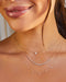 Graduated Diamond Necklace in 14k yellow gold styled on neck of model with full cut heart necklace and 9 prong diamond necklace