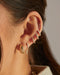 Prong Set Double Drop Huggie Earring in 14k yellow gold styled on ear of model with gold dome earring and four diamond earrings