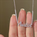 Luxe Diamond Script Name Necklace in 14k white gold with initials AUSTIN held in hand and put on neck of model with no audio