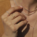 Gold Mesh Necklace in 14k yellow gold styled on neck of model with multiple gold and diamond layers on neck and wearing yellow blouse with no audio