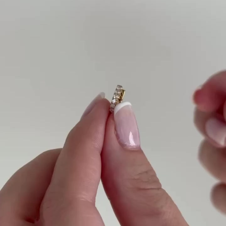 Reversible Diamond & Turquoise Mini Huggie Earring held in between fingers with no audio