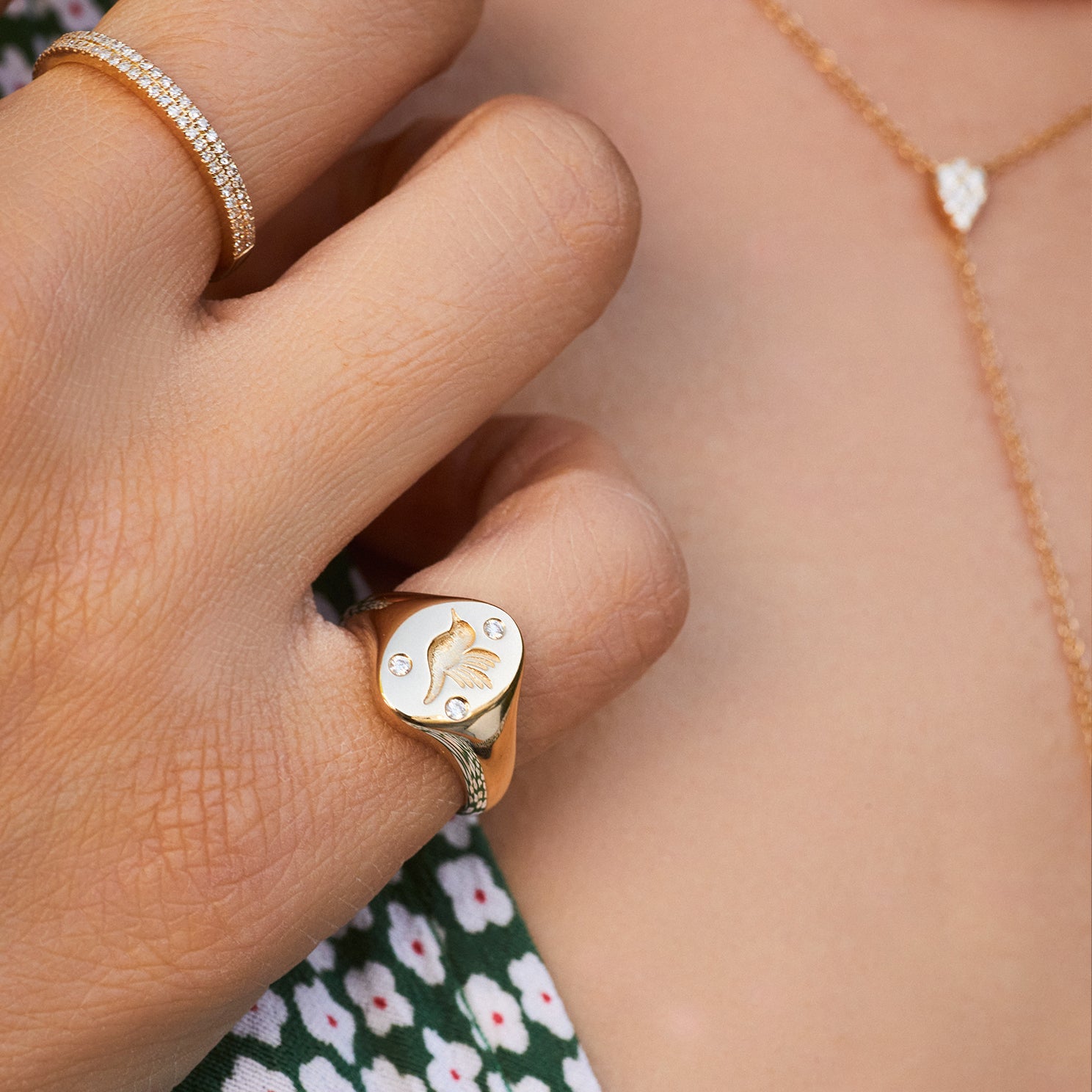 Diamond Hummingbird Signet Ring in 14k yellow gold styled on pinky ring of model