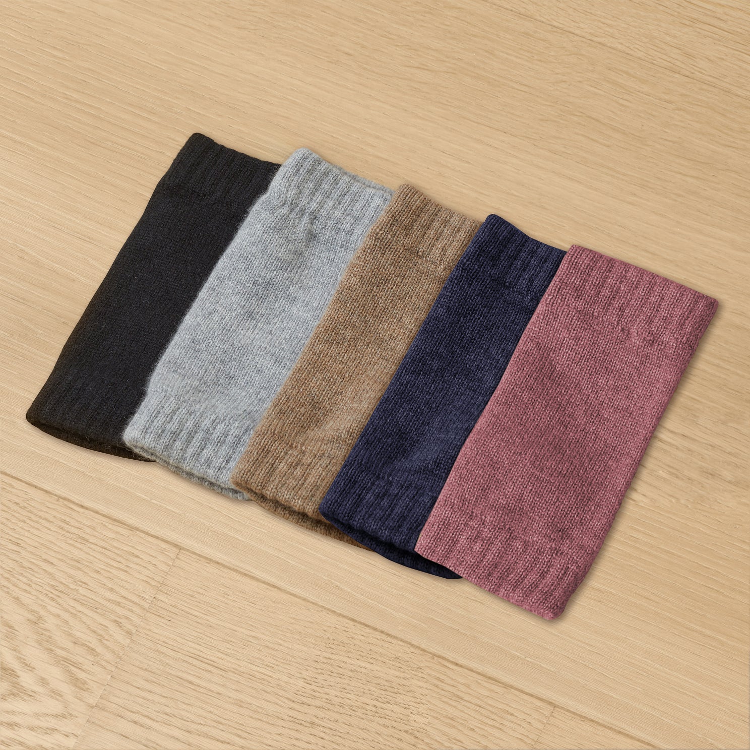 Five cashmere wrist warmers in colors black, grey, mocha, midnight blue, and mauve