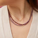 Gold Heart and Diamond Arrow Necklace in 14k Yellow Gold Styled on Neck with Birthstone Bead Necklaces Layered