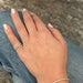 Diamond Swirl Ring in 14k yellow gold styled on pinky ring of model