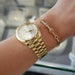 Gold and Diamond Custom Name Bracelet styled on the wrist in yellow gold