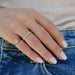 Half Diamond Baguette Eternity Stack Ring on the hand in yellow gold
