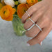 Custom Baguette Diamond Initial Ring in 14k yellow gold with the initial S styled on pinky ring of model next two two bagette rings