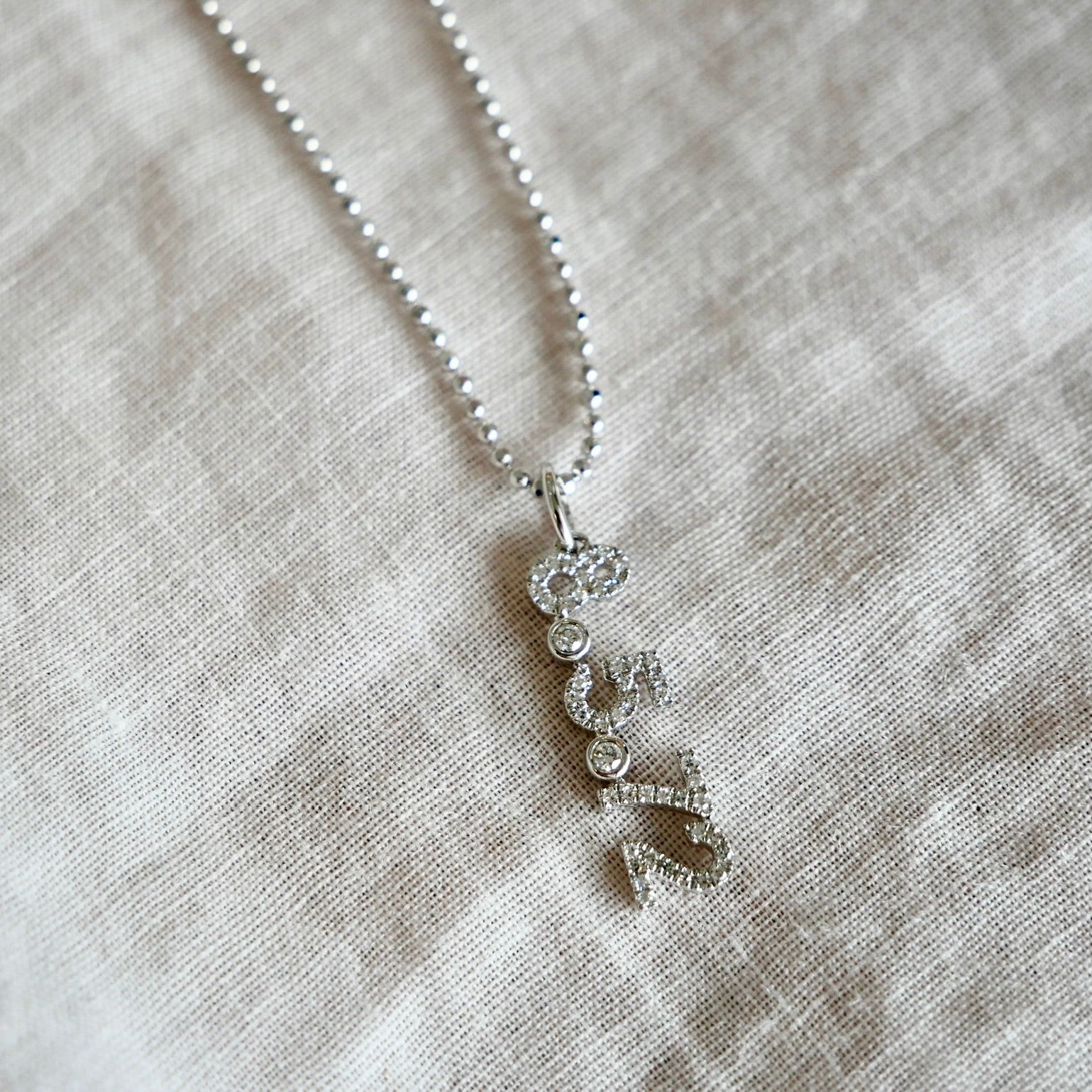 Diamond Custom Date Charm Necklace shown in white gold