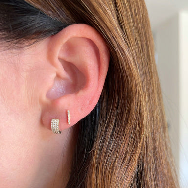 Diamond Jumbo Huggie earring on the ear in yellow gold