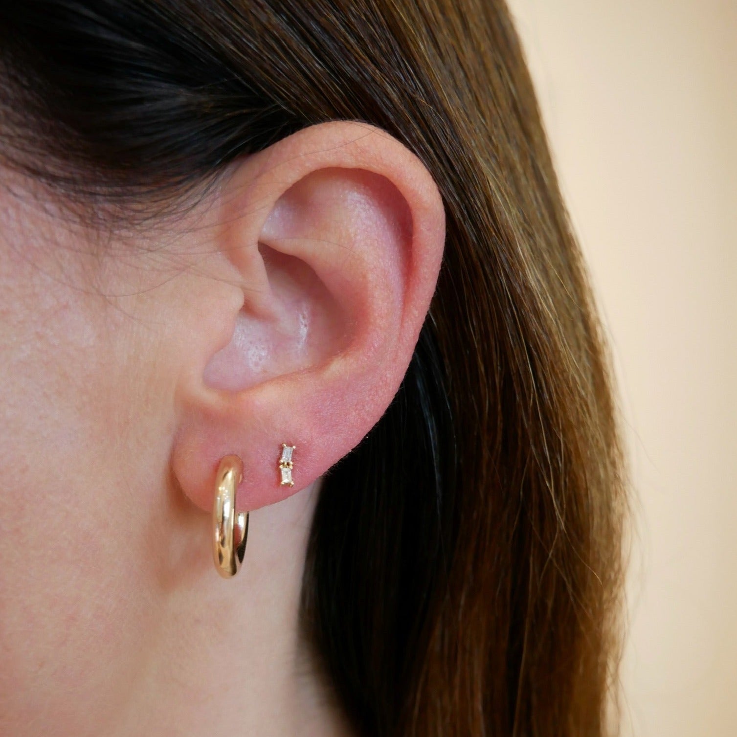 Double Baguette Dangle Stud Earring in Yellow Gold styled on ear