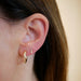 Double Baguette Dangle Stud Earring in Yellow Gold styled on ear