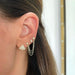 Baby Diamond Star Stud Earring styled on the ear in yellow gold