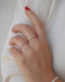 Diamond Eternity Band Ring in 14k Yellow gold styled on ring finger of model wearing white shirt
