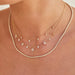 Margo Necklace in 14k yellow gold styled on neck of model with teardrop necklaces