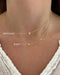 Baby Diamond Star And Gold Moon Necklace in 14k yellow gold styled on neck of model below the regular star necklace in gold