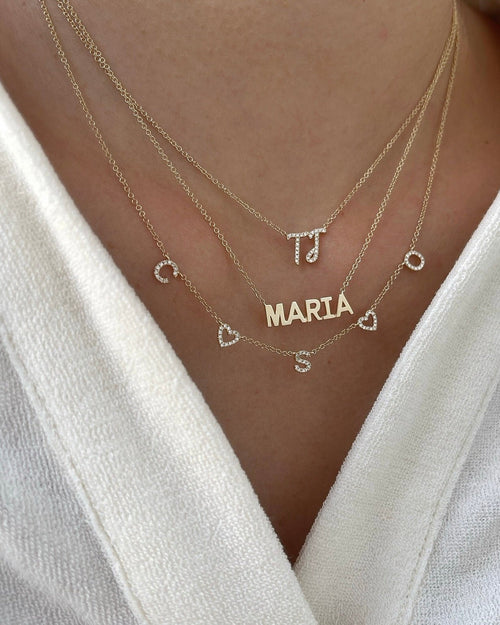 Gold Custom Initial Necklace styled on the neck in yellow gold