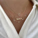 Gold Custom Initial Necklace styled on the neck in yellow gold