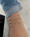 Diamond Block Name Curb Chain Bracelet styled on the wrist in yellow gold