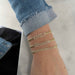 Diamond Block Name Curb Chain Bracelet styled on the wrist in yellow gold