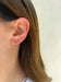 Ruby Mini Huggie Earring in 14k yellow gold styled on first earring hole on earlobe of model