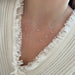 Love Around the Neck Necklace styled on the neck in yellow gold