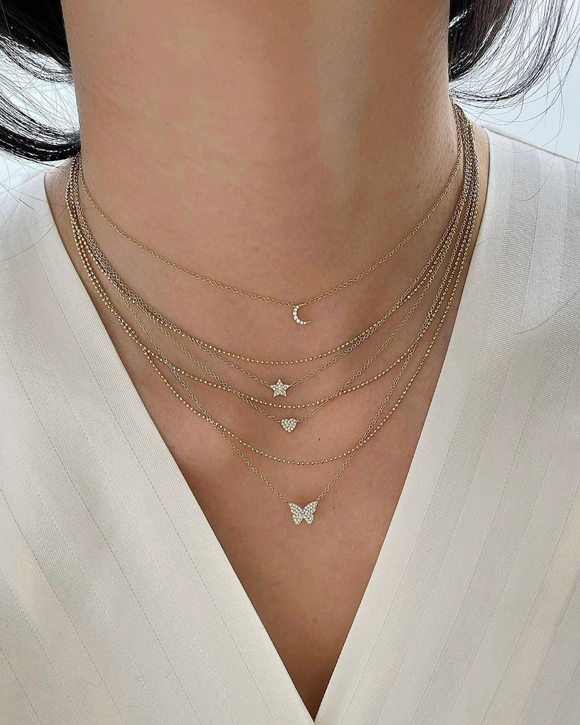 Diamond Butterfly Necklace on the neck in yellow gold