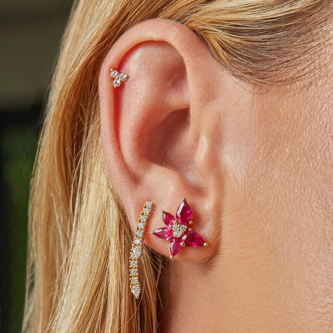 Ruby and Diamond Trio Cluster Stud Earring in yellow gold styled on the ear