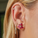 Ruby and Diamond Trio Cluster Stud Earring in yellow gold styled on the ear