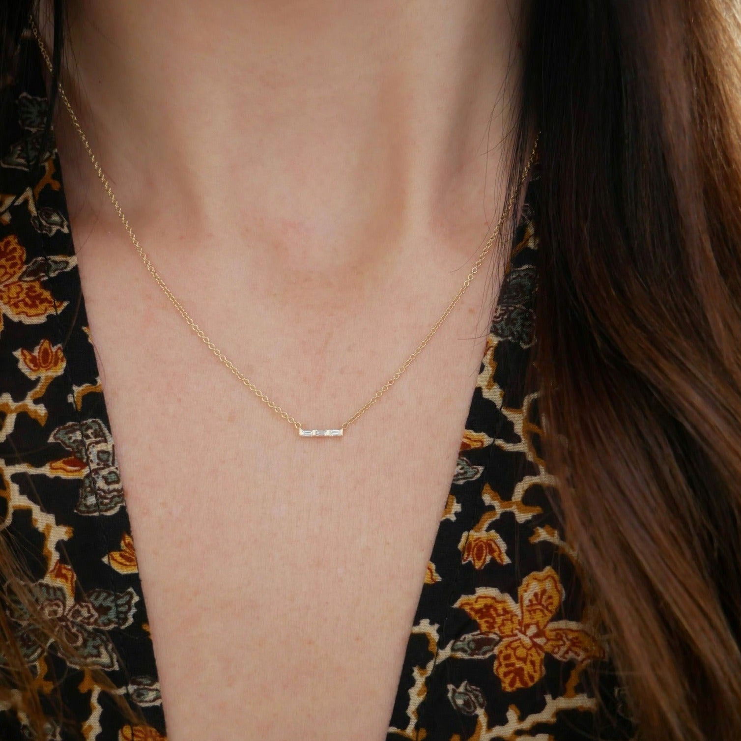 Baguette Mini Bar Necklace styled on the neck in yellow gold