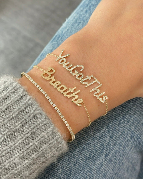Script Gold Custom Name Bracelet styled on the wrist in yellow gold