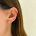 14k (karat) yellow gold mini huggie with 6 marquise diamonds (3 on each huggie) at 0.19 carats styled on ear