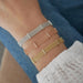 Diamond Bar Mesh Bracelet in 14k white gold, rose gold, and yellow gold styled on wrist of model wearing white blouse