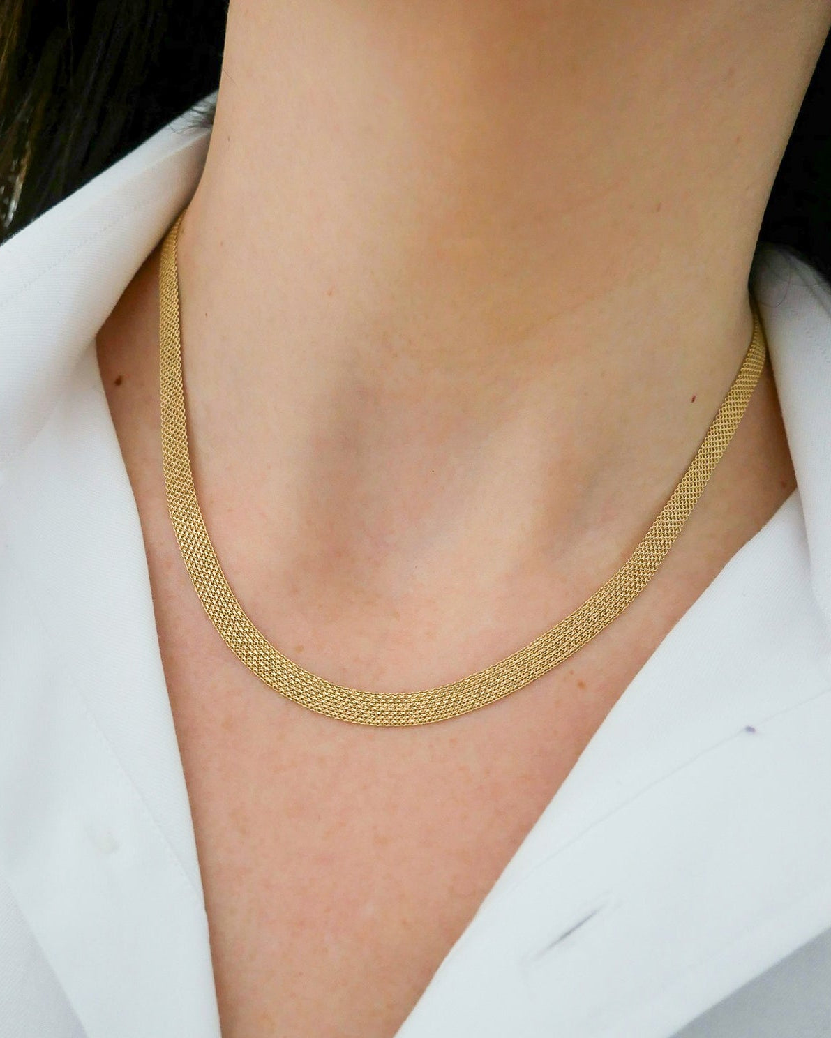 Gold Mesh Necklace in 14k yellow gold styled on neck of model wearing white blouse